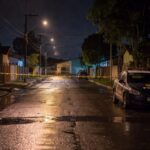 Rua vazia em Sobradinho com viatura da polícia e fita de isolamento, local de briga fatal no Distrito Federal.